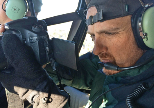 Kevin Wagner, another Founder and Partner at Unmanned Productions, LLC, takes aerial photography and videography from a helicopter.