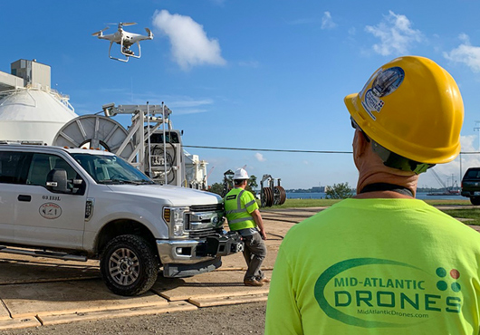 Mid-Atlantic Drones, LLC’s Mike Sobola captures images to support the installation of new power transmission cables near the Francis Scott Key Bridge in Baltimore.