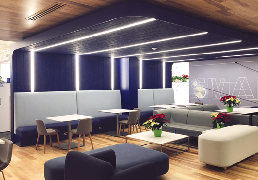 At iRobot in Bedford, MA, Mass Cabinets Inc. uses reclaimed wood and fabric banquettes to create warm first impressions. 