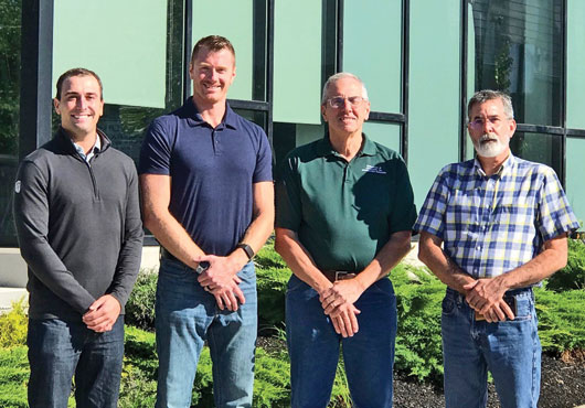 (From left to right): Keegan Taylor, Eric DeStefano, John DeStefano and Robert Fournier stand in front of the Veridian Residences apartment building in Portsmouth. This $20 million project is DeStefano & Associates, Inc.’s largest to date.