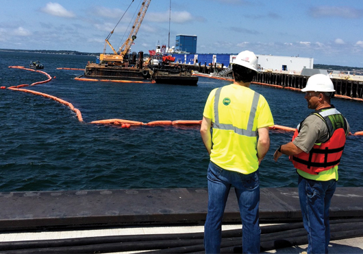 A Surety Bond Professionals, Inc.’s underwriter joins a client at a job site where dredging work is being performed.