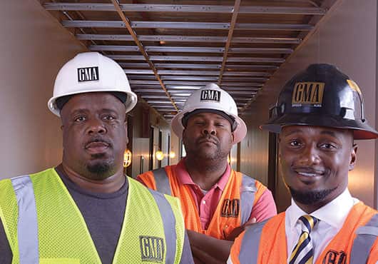 GMA Construction Group hires people like Carl Nesbitt, Assistant Superintendent (pictured on the left) from within the housing communities it renovates.  Also shown are Deon King, Superintendent (middle)  and Cornelius Griggs, President.