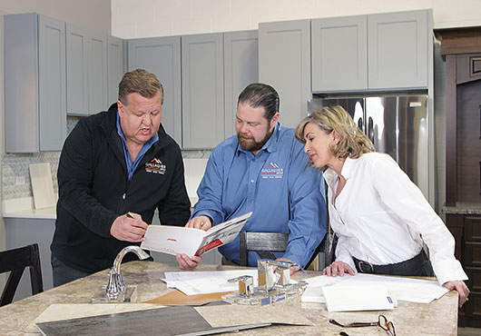From left to right, Timothy Sandefur and Michael K. Gallagher with Dawn Keith, Director of Marketing, discuss a current project at the Gallagher Contractor Supply and Materials warehouse.