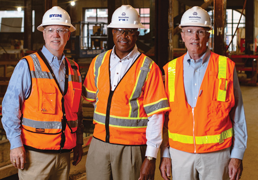 Martin Lehman (left), Micheal Williams and Bob Bowen stand in the first-floor, main-entry corridor in what was known as The Records Building. Exposed structural steel is visible in addition to part of the original ceiling that will remain in place. The elevators for The Records Building used to be located just left of the men.