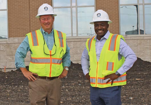 Left to right: Jason Haralson, Sr. Vice President of Satterfield & Pontikes Construction, Inc., and Trelaine Mapp, President and CEO of Source Building Group, Inc., standing on the east side of the South Dallas Government Center job site.