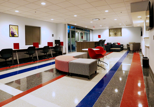 Public-facing reception lobby for the new Dallas County Elections Operations Facility featuring a waiting lounge, a secured check-in and work stations.