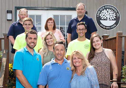 Shane Stein (front left), Mark Stein (center) and Jackie LaCross are joined by family members and long-term key employees for a photo at Land-Tech Enterprises, Inc. offices in Warrington, PA.