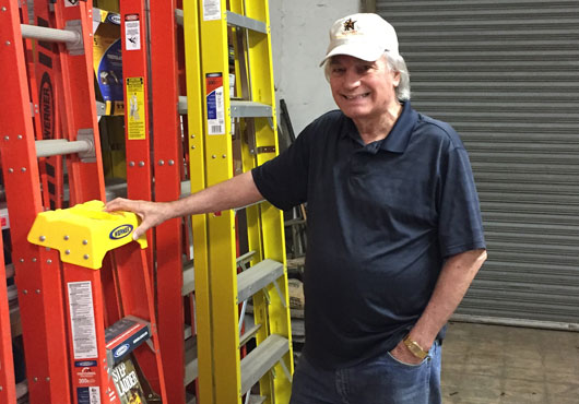 Cody Voss, husband of A B Ladder Company President Suzy Voss, poses in the ladder warehouse.