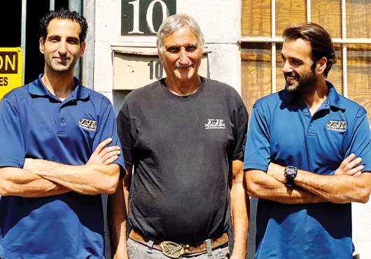 Sons Nir (left) and Coby Cohen (far right) enjoy working in a family business environment with their dad, Joe Cohen (center).