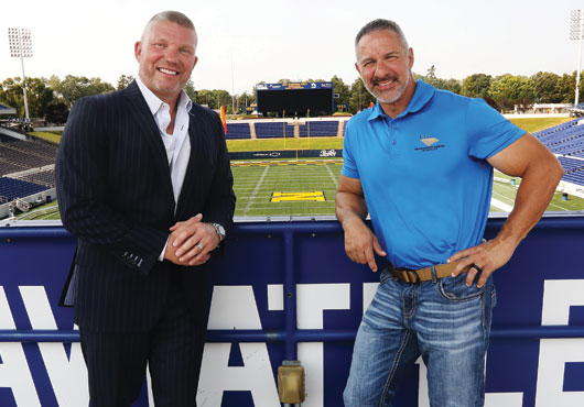 Grandstand Design Enterprises, Inc. President Chris Howard (left) and Project Manager Andrew Sarmast show off the Navy-Marine Corp Memorial Stadium in Annapolis, where the company completed several renovation projects between 2003 and 2016.