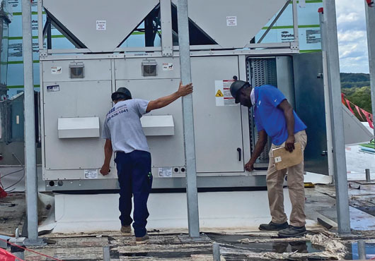 Hugee Corporation employees install the HVAC systems at 1100 Eastern Ave. NE, a mixed-use property in Washington, D.C., built by longtime contractor and partner Hamel Builders.