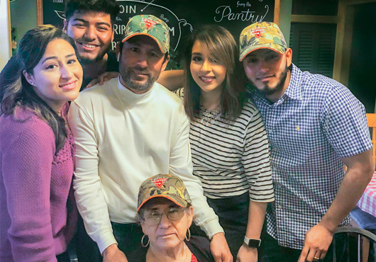 Mondragon Paving President/Owner Isidro Mondragon (center with this family) launched his full-service asphalt paving company in 2016. He credits his mother, Carlota (seated), with much of his success.
