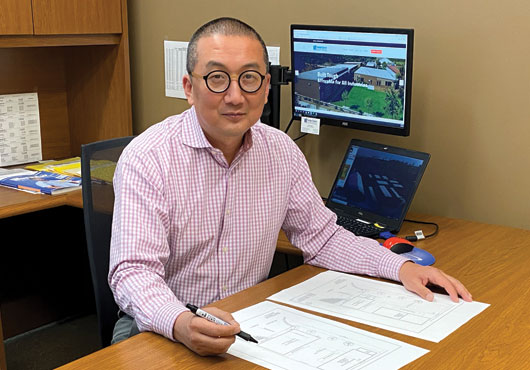 Peter Synn, Regional Sales Manager for Design Space Modular Buildings, reviews site plans before a customer delivery.