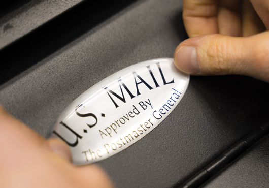 All mailboxes sold by Mailbox Solutions bear this distinctive oval seal signifying they are approved by the USPS Postmaster General.