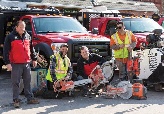 From left to right: Howard Bishop, Matthew Dodge, Jeffrey Bishop, Albert Marino, with some of the many tools of the trade. Suburban Sales & Service Corporation prides itself on keeping up to date with the latest technology in the industry.