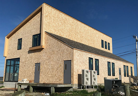 The completed renovation of a 4,000-square-foot waterfront corporate office in Rhode Island called The Town Dock, the largest supplier of fresh squid in the U.S.