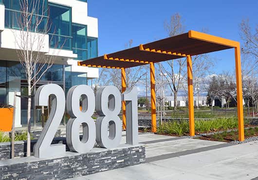 San Jose Awning, doing business as Visible Innovations Group, fabricated and installed this custom-designed, combined aluminum and Ipe wood trellis in Santa Clara, Calif., to emphasize the previously difficult-to-locate building entry for the nearly 100,000-square-foot office complex.