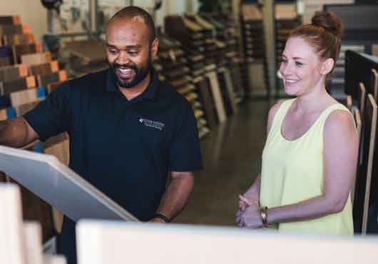 Inside of the company’s retail showroom, CEO Clayton Rodrigues assists a customer with selecting the best material for her project.