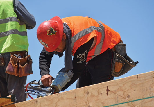 A member of the Six Star Framing Concepts joist crew completes the flooring in one part of the framing construction project.