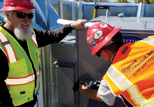 Primary Mechanical, Inc. prepares for the start-up of a Carrier® air conditioner unit.