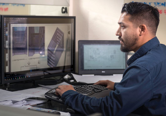 Julio Perez, lead draftsman, working on a design build project.