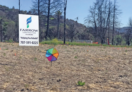 A Farrow Construction marker at the former site of a family’s home destroyed by wildfire. The marker suggests hope is still alive for the family to rebuild and return.