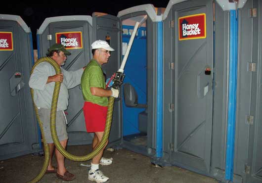 At Northwest Cascade Inc., everyone gets involved. Here, owner Mark Perry (left) and past President Steve Barger clean restrooms at the Hood to Coast Relay in Oregon.  