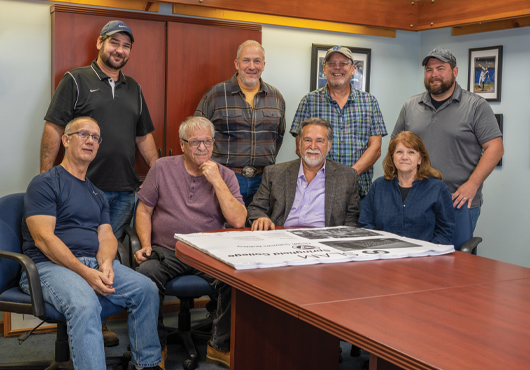 DeBrino Caulking Associates, Inc. President and Owner Lewis P. Houghtaling III (bottom row, second from right) meets with project managers and estimators (from left) Charles Lyman, T.J. Dugan, Joe Lazzara, Rich Farnan, Alan Ingram, Doris Della Rocco and Brandon Lapp.