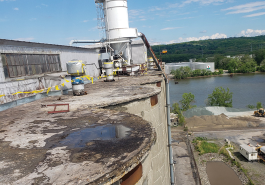 DeBrino Caulking Associates, Inc. performs a wide variety of maintenance and repair services, including on this Ardent Mills grain silo at the Port of Albany. The firm demolished, then formed and poured the concrete top edge of the silo.