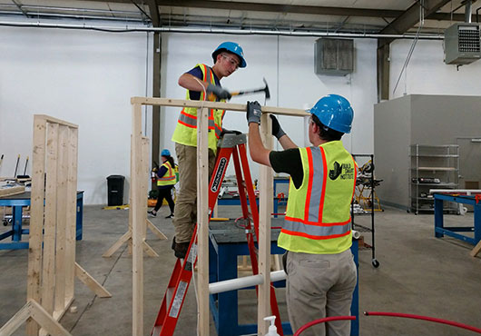 High school students in the Build Smart Institute lab learn carpentry skills and how to work effectively and safely as a team. 
